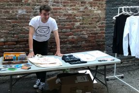 Student Connor Murray selling cassette tapes and merchandise at a table