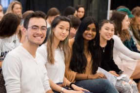 A group of students smile for the camera