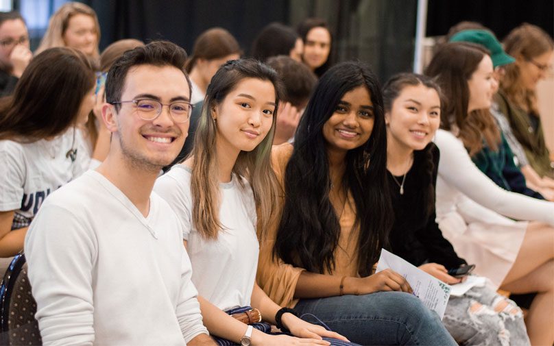 A group of students smile for the camera