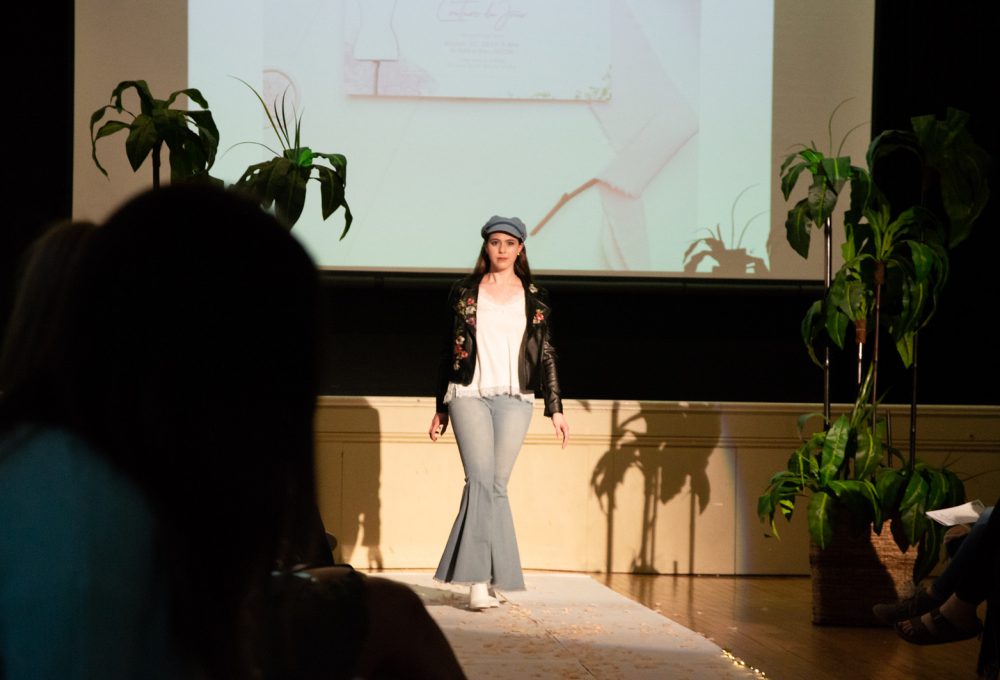 Another girl walks down the runway