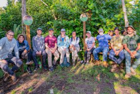 Students and community members pose in a field in Puerto Rico