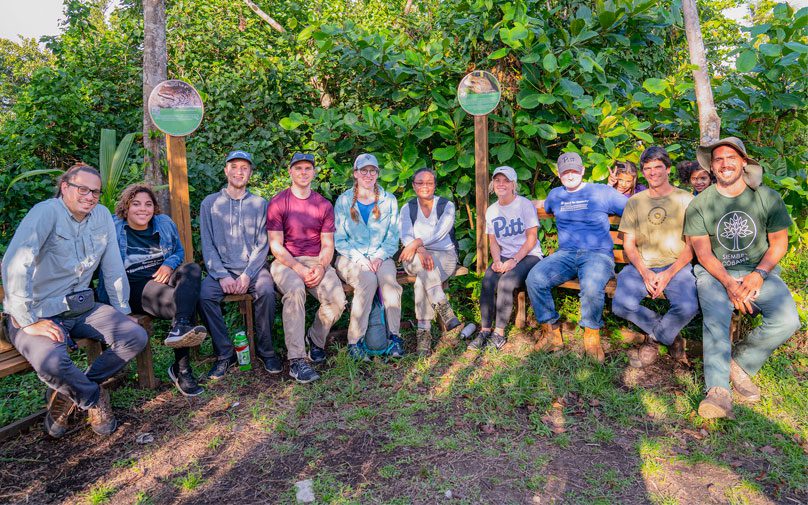 Students and community members pose in a field in Puerto Rico
