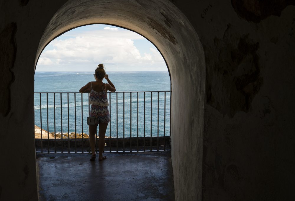 A student overlooks the ocean in Puerto Rico